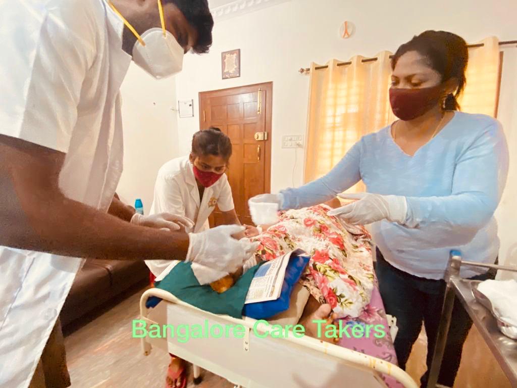 Staff member assisting a resident at Bangalore Care Takers